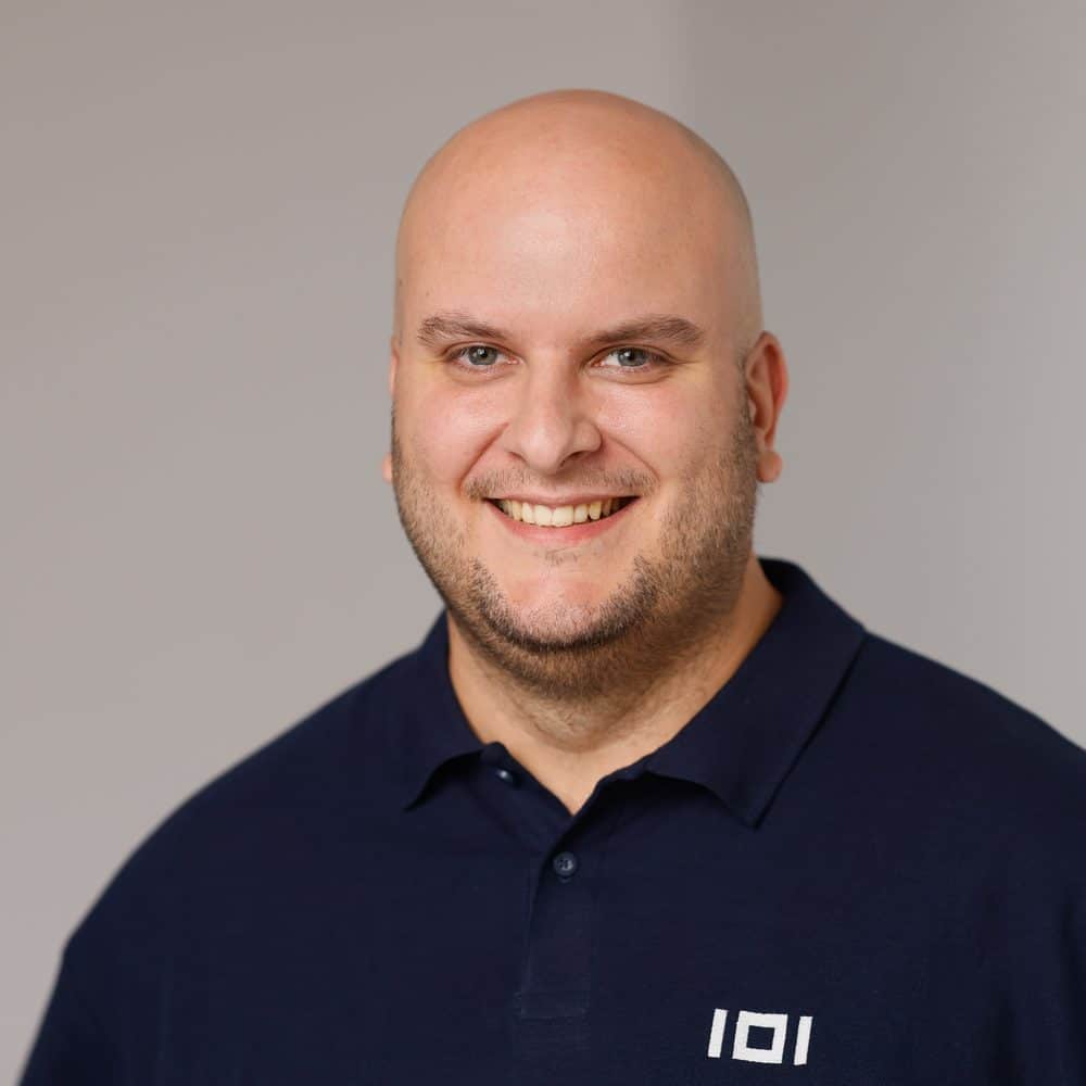 Sascha Marquardt, Managing Director of IO Integrated, wearing a navy polo shirt with the IOI logo