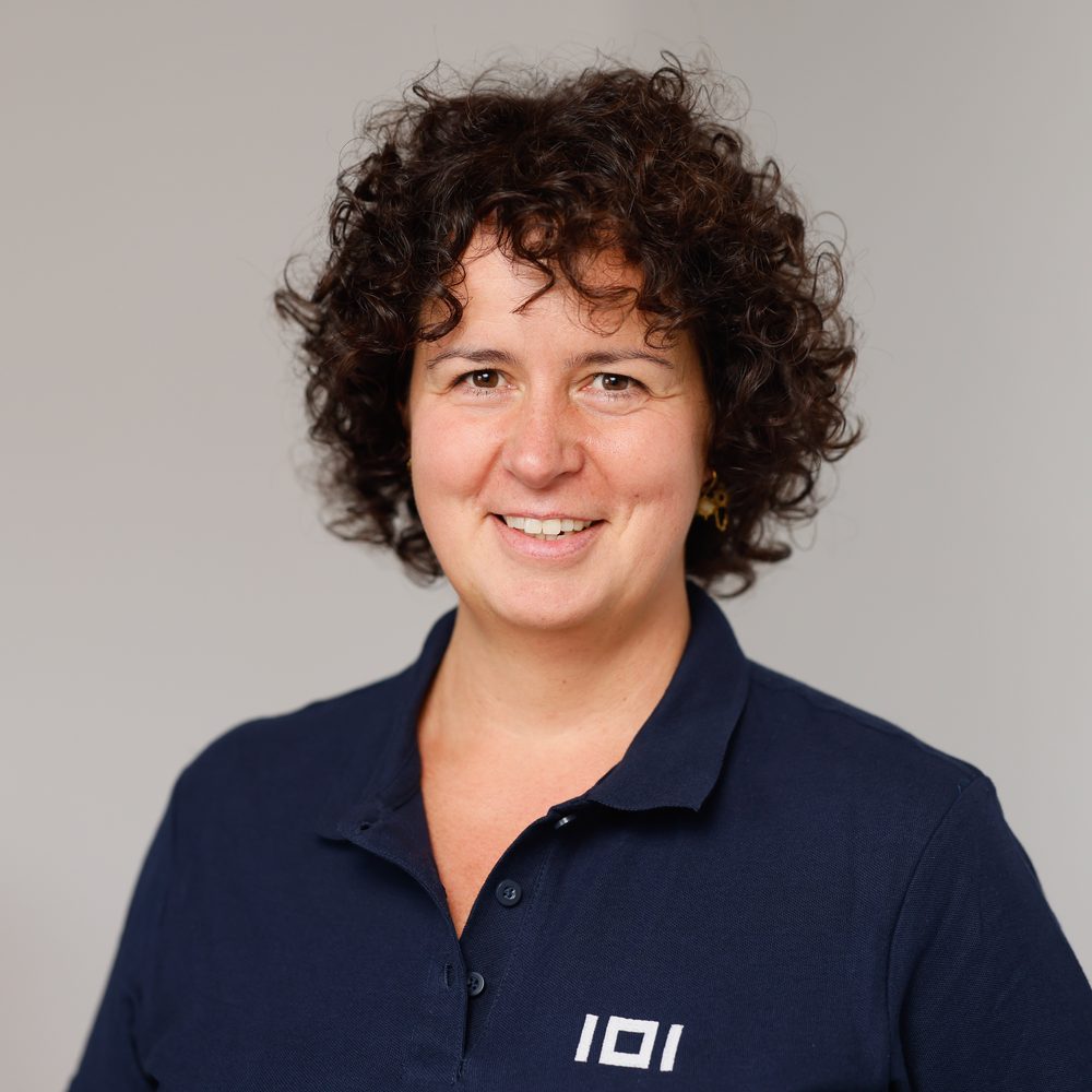 Susanne Reinke, Senior Finance & Business Consultant at IO Integrated, wearing a navy polo shirt with the IOI logo